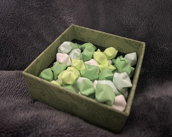 Multi green and white origami stars in a box