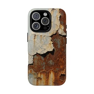 May include: A smartphone case featuring a weathered, distressed design. The case has a textured appearance with peeling paint in shades of gray, white, and rust-brown, creating a vintage or industrial aesthetic. The camera lenses are visible at the top.