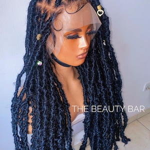 May include: A black lace front wig with long, loose dreadlocks. The wig is styled with small gold and clear beads.