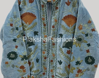 May include: A light blue jacket with intricate floral embroidery in shades of brown, green, and orange. The jacket features a high collar and a striped lining. The text "PlakshaFashions" is visible on the jacket.