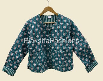 May include: A teal quilted jacket with a floral pattern in white and pink. The jacket has long sleeves, a V-neck, and a button closure. The cuffs and inner collar feature a striped design. The brand name "Plaksha Fashions" is visible.