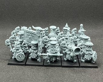 May include: A collection of gray miniature fantasy figures, including warriors with shields, banners, and horns. Some figures hold weapons and musical instruments. The figures are arranged on black bases.