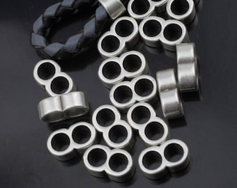 May include: Silver-toned metal beads with two holes each, designed for use in jewelry making or crafting projects.