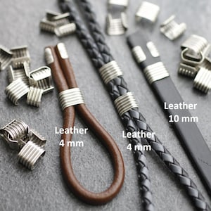 May include: An assortment of leather cords and metal findings. The image shows a brown leather cord (4 mm), a black braided leather cord (4 mm), and a black leather strip (10 mm). Silver-colored metal findings are also visible.