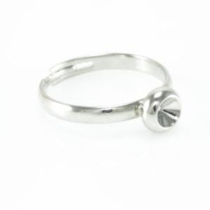 May include: A silver ring featuring a round, cone-shaped design. The adjustable ring sits on a white surface. The ring's band is smooth and polished, reflecting light. The ring is made of a shiny metal.