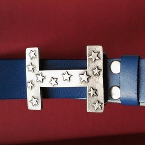 May include: A blue leather belt with a silver buckle featuring a large letter "H" with stars around it.