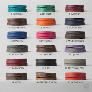 May include: A color chart displaying twenty leather strap samples in various hues including turquoise, sea green, burgundy, brown, orange, blue, fuchsia, grey, violet, cherry, black, and red, each labeled with a number and color name.