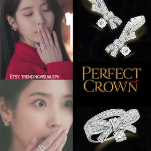 May include: A collection of diamond-studded jewelry, including a ring and earrings, with a bow design. The ring features a large, central diamond. The image also includes the text "PERFECT CROWN".
