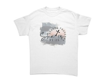 May include: White t-shirt with a watercolor design featuring the text "She is 31:25" in a script font, with "Strong Proverbs" in a circular arrangement. The design includes a cross and a color palette of gray, pink, and white.