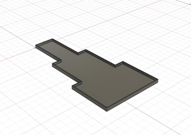 Puede incluir: Objeto rectangular gris renderizado en 3D con un dise&ntilde;o escalonado. El objeto tiene un borde elevado alrededor de su per&iacute;metro, creando un borde definido. El fondo presenta un patr&oacute;n de cuadr&iacute;cula.