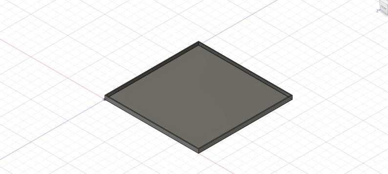 Puede incluir: Un objeto cuadrado gris con un borde gris oscuro. El objeto est&aacute; en &aacute;ngulo, mostrando su forma geom&eacute;trica sobre un fondo de cuadr&iacute;cula. El dise&ntilde;o parece ser un modelo 3D o una representaci&oacute;n digital.