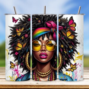 May include: A stainless steel tumbler with a colorful design featuring a woman with long, curly hair, a rainbow headband, and butterflies. The tumbler has a white background with splashes of paint.