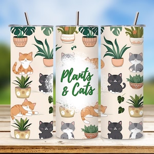 May include: A cylindrical tumbler decorated with illustrations of plants and cats. The design includes the text "Plants & Cats". The background is a light beige colour. The tumbler has a silver straw.