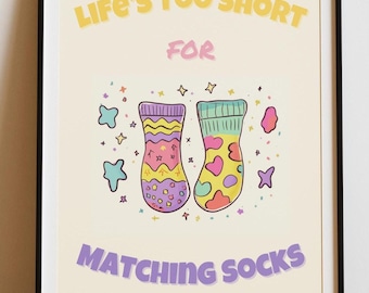 May include: A colorful print with the text "Life's Too Short For Matching Socks" in yellow and purple. The print features two mismatched socks with a rainbow pattern and hearts.