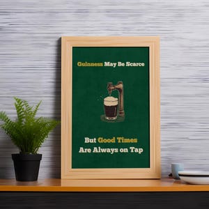May include: A framed green poster with the text "Guinness May Be Scarce But Good Times Are Always On Tap". The poster features a cartoon illustration of a beer tap pouring a glass of Guinness.