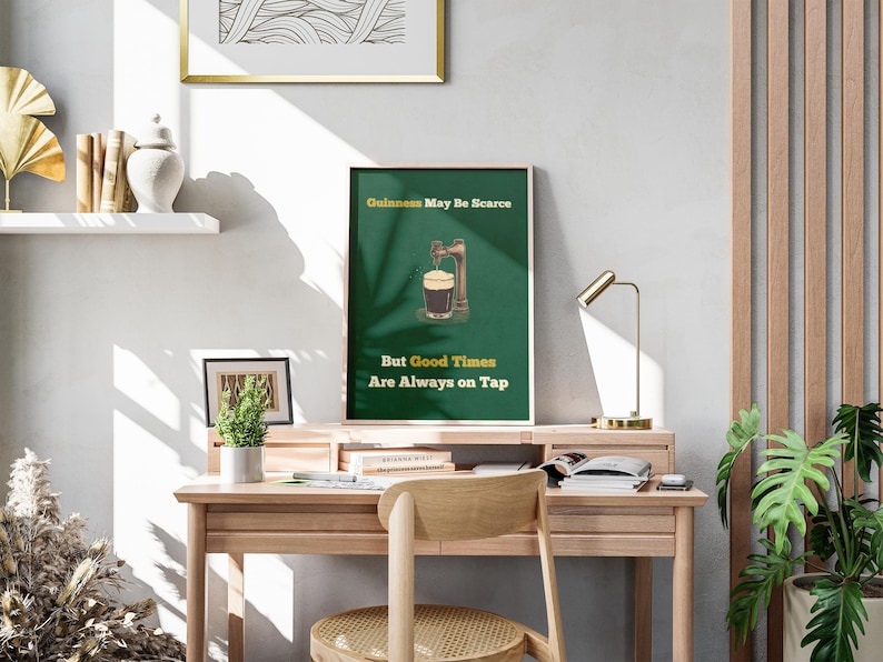 May include: A green and white poster with the text "Guinness May Be Scarce But Good Times Are Always On Tap". The poster features an illustration of a pint of Guinness being poured from a tap.