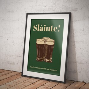 May include: A green poster with the text "Sl&aacute;inte!" in a yellow font. Three glasses of dark beer are arranged in a triangle shape. The text "Here's to health, wealth, and happiness" is at the bottom of the poster.