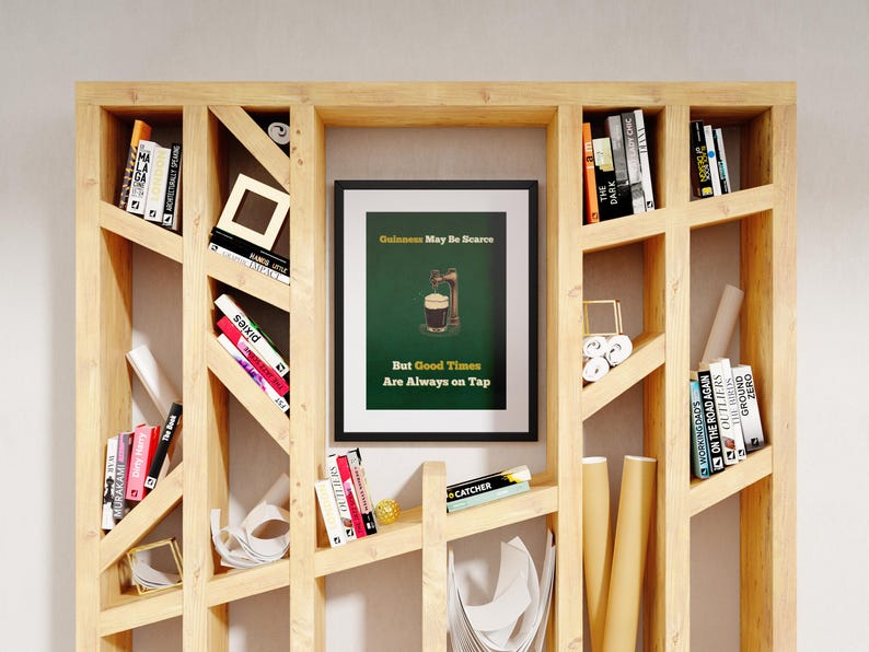 May include: A framed print with a green background and a glass of beer with a tap. The text on the print reads "Guinness May Be Scarce But Good Times Are Always On Tap".