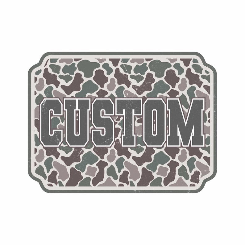May include: A rectangular graphic with a camouflage pattern in shades of green, brown, and gray. The word "CUSTOM" is displayed in bold, gray letters with a white outline. The design has a distressed, vintage look.