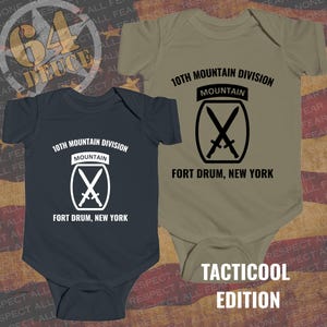 May include: Two baby onesies, one navy blue and one olive green, each featuring the text "10th Mountain Division" and a crossed swords emblem. The text "Fort Drum, New York" is below the emblem. The words "Tacticoool Edition" are at the bottom.