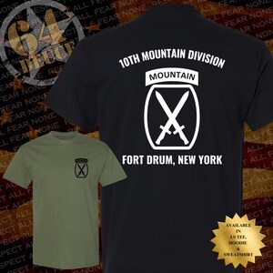 May include: Two t-shirts, one black and one olive green, featuring the 10th Mountain Division logo. The black shirt displays the text "10th Mountain Division" and "Fort Drum, New York." The olive green shirt has the logo on the chest.
