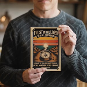 May include: A book with the text "TRUST IN THE LORD WITH ALL YOUR HEART" in a black frame. The cover features a sunset scene with a compass. The text "LEAN NOT ON YOUR OWN UNDERSTANDING HE WILL MAKE YOUR PATHS STRAIGHT PROVERBS 3:5-6" is also on the cover.