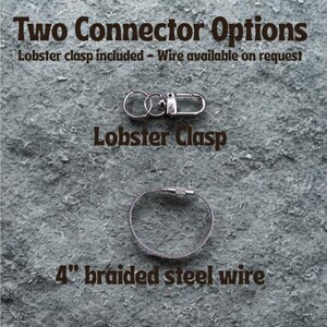 May include: Image showing two connector options. The top option is a silver lobster clasp. The bottom option is a 4-inch braided steel wire. Text at the top reads "Two Connector Options".