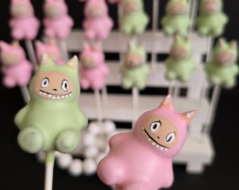 Labubu cake pops pink, blue green yellow  reveal party baby shower annyversary cake pop on a stand.0