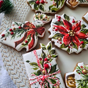 May include: A collection of gingerbread cookies decorated with white icing and hand-painted designs including red poinsettias, green foliage, gold accents, and red and white striped icing strings, arranged on a textured white platter.