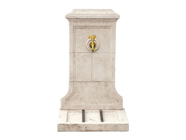 May include: A white stone fountain with a gold faucet and a small basin at the bottom.