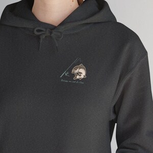 May include: A black hoodie with a pocket on the front. The hoodie has a small graphic of a fish on a fishing rod with the text "Fishing is not a job it's a life" printed on the front.