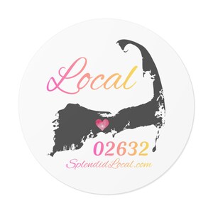 May include: A circular sticker with a white backdrop displays a grey landmass silhouette, a pink heart, and the word "Local" in a pink to yellow gradient. Beneath the heart, the number "02632" is shown in pink and yellow.