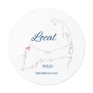 May include: A white circle sticker with a black outline of Cape Cod, Massachusetts. The sticker has a red heart in the center of the Cape, and the text "Local" in blue cursive above the Cape. The text "02532" and "SplendidLocal.com" are below the Cape.