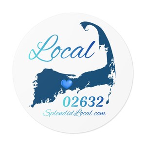 May include: A circular white sticker featuring the word "Local" in a blue gradient script. A dark blue outline of a landmass with a blue heart is in the center. Below is the number "02632" and the website "SplendidLocal.com".