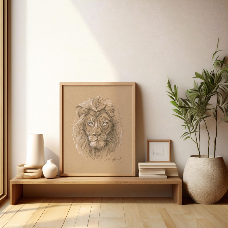 May include: A framed pencil drawing of a lion's head with a brown background. The lion has a thick mane and is looking directly at the viewer.