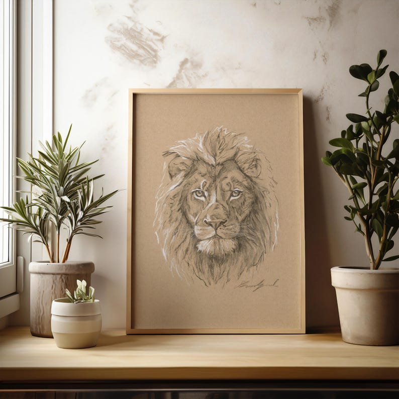 May include: A framed pencil drawing of a lion's head on a brown background. The lion has a thick mane and is looking directly at the viewer.