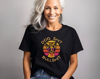 May include: Black t-shirt with a graphic of a dog wearing sunglasses in front of a sunset with the text "Dog Shit Over Bullshit".