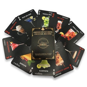 May include: A deck of playing cards with black backgrounds and colorful cocktail illustrations. Each card features a different cocktail recipe with the name of the drink and the primary liquor used. The box features the text "America's Favorite Cocktail Recipes" and "Official Cocktail Cards".
