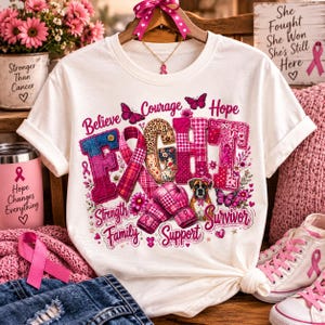 Peut inclure: Un t-shirt blanc avec une impression graphique affichant le mot FIGHT en grandes lettres à motifs, entouré de rubans roses, de papillons, de gants de boxe, d'un chien et des mots Believe, Courage, Hope, Strength, Family, Support et Survivor.