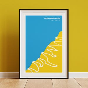 May include: Framed art print featuring a minimalist design with a blue sky and yellow mountain. White squiggly lines represent a path. The text "Locets de Montvernier" is at the top. The artwork is displayed on a yellow wall.