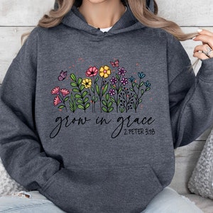 May include: Gray hooded sweatshirt with a floral design and the text "grow in grace 2 Peter 3:18".