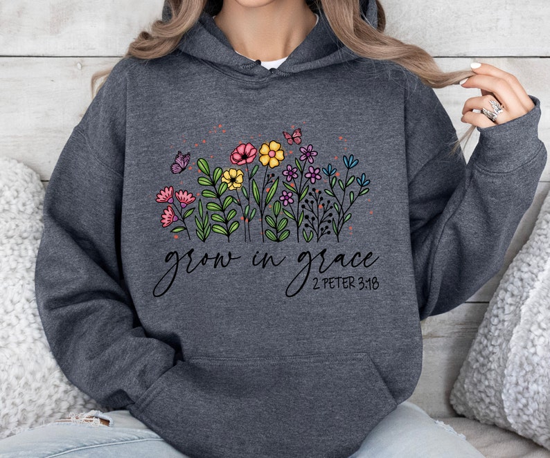 May include: Gray hooded sweatshirt with a floral design and the text "grow in grace 2 Peter 3:18".