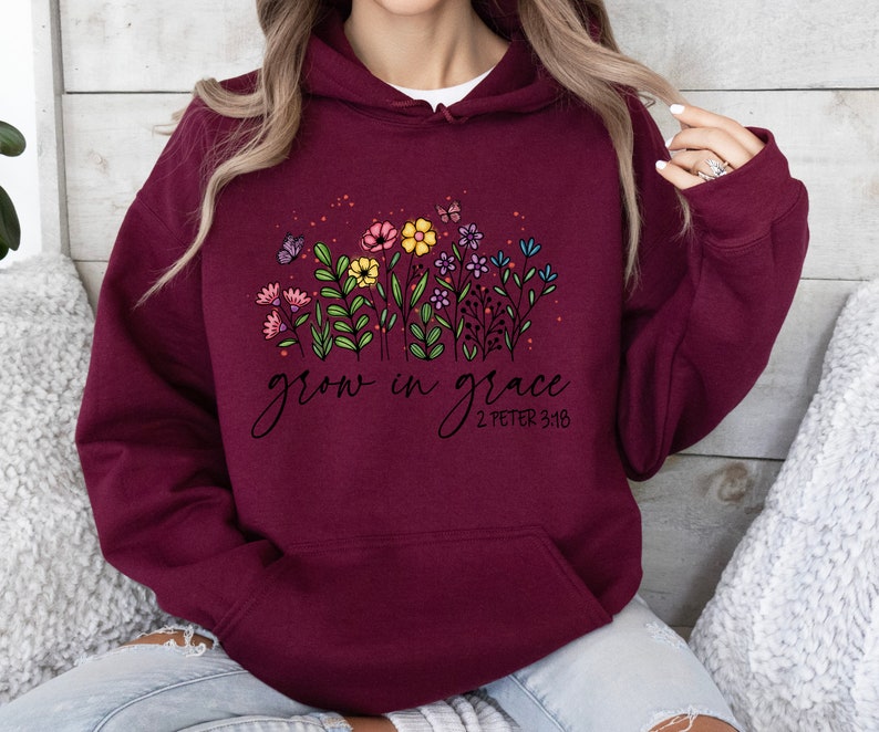 May include: Burgundy hooded sweatshirt with a floral design and the text "grow in grace 2 Peter 3:18".