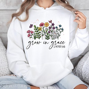May include: White hoodie with a floral design and the text "grow in grace 2 Peter 3:18".