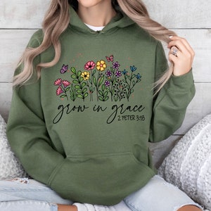 May include: Green hooded sweatshirt with a floral design and the text "grow in grace 2 Peter 3:18"