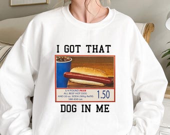 May include: White sweatshirt with a graphic of a hot dog and soda with the text "I GOT THAT DOG IN ME" and "1/4 POUND PLUS ALL BEEF HOT DOG AND 20 oz. SODA (Witg Refill) 580-850 cal. 1.50"