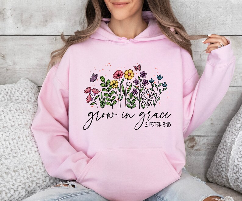 May include: Pink hoodie with a floral design and the text "grow in grace 2 Peter 3:18".
