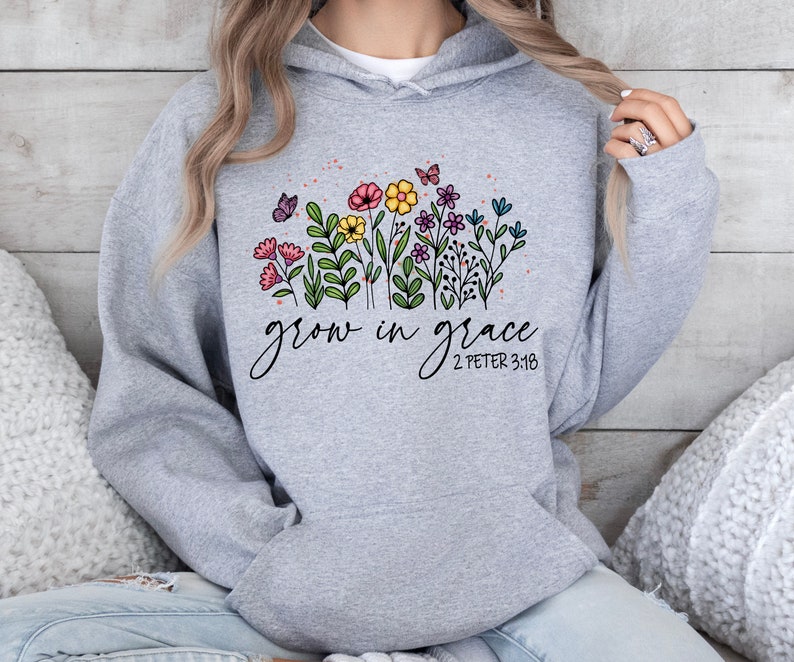 May include: Gray hooded sweatshirt with a floral design and the text "grow in grace 2 Peter 3:18".