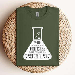 May include: A green t-shirt with a white graphic of a beaker with the text "Who wants to be a princess when you can be a scientist".