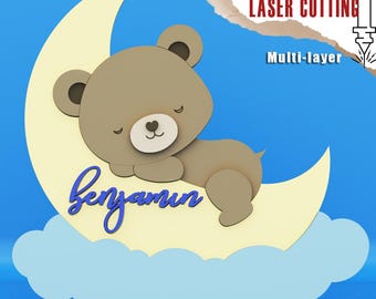 May include: A multi-layered digital file for laser cutting, featuring a sleeping bear on a crescent moon and cloud. The bear is light brown, the moon is yellow, and the cloud is light blue. The name "Benjamin" is written in blue script. Text includes "DIGITAL FILE FOR LASER CUTTING".